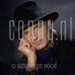 Barry Hughes (Date Unknown) at studio in Amsterdam.

[keywords]Headshot, Eyecontact, Smiling, Hat[/keywords]